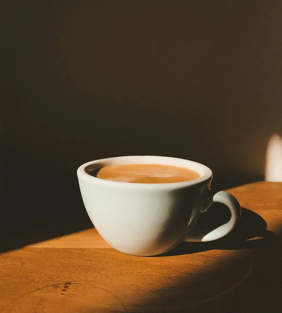 Freshly made cup of coffee on a wooden table